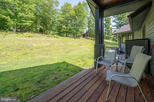 wooden deck featuring a lawn