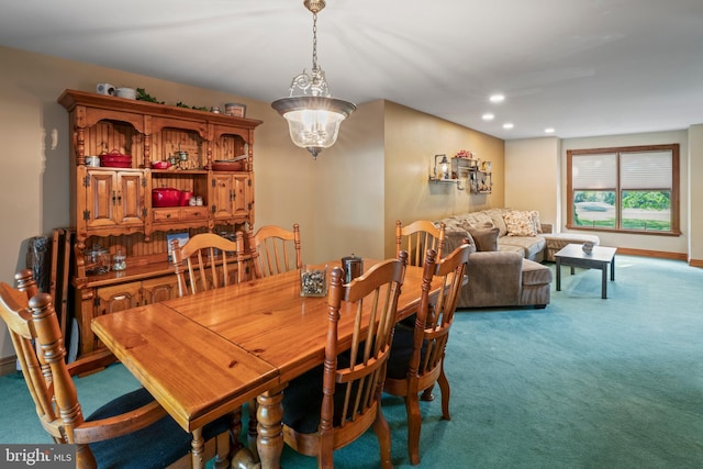 dining room featuring an inviting chandelier and carpet floors