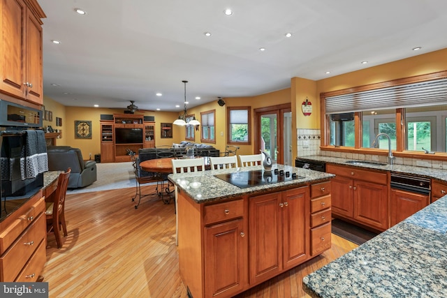 705 Franklinville Rd, Mullica Hill, NJ 08062 - kitchen with brown cabinetry, open floor plan, a kitchen island, a sink, and black appliances
