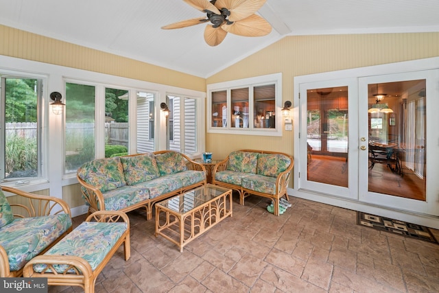 sunroom / solarium with ceiling fan, vaulted ceiling, and french doors