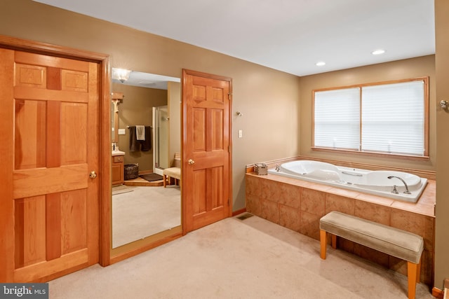 bathroom featuring a relaxing tiled tub