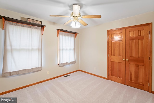 spare room with carpet floors and ceiling fan