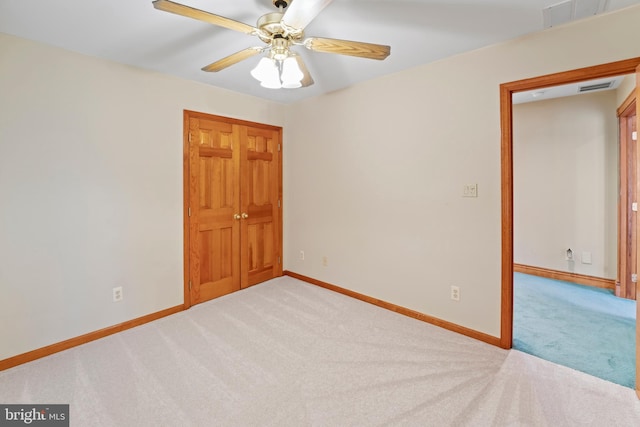 empty room featuring ceiling fan and carpet floors