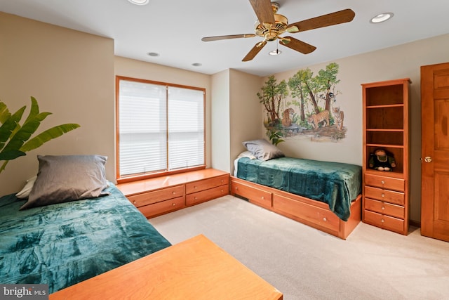 bedroom featuring ceiling fan and light carpet