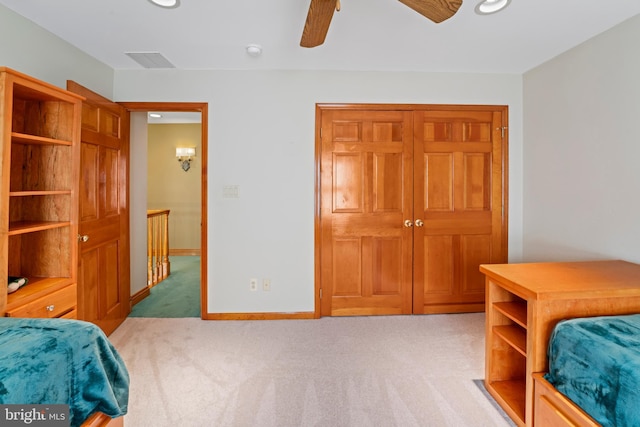 bedroom with ceiling fan and light colored carpet