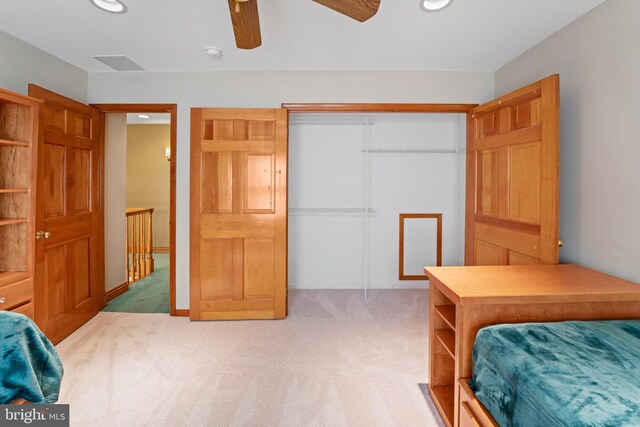 bedroom featuring ceiling fan and light carpet