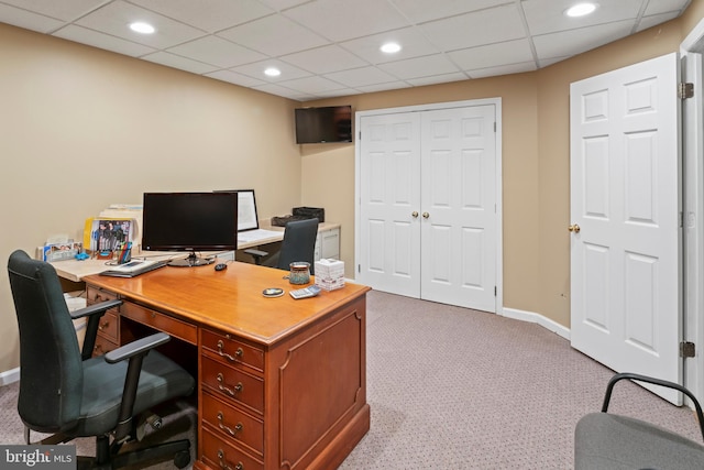 office featuring a paneled ceiling and light colored carpet