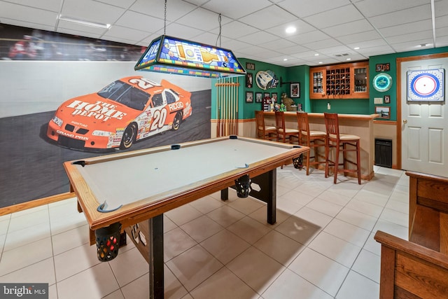 game room with bar, tile patterned flooring, pool table, and a drop ceiling