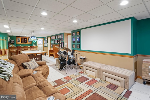 home theater room featuring light tile patterned floors, pool table, and a paneled ceiling