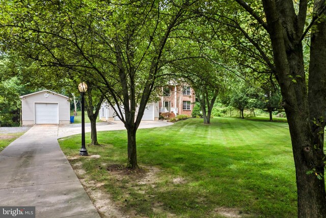 view of front of home featuring a front yard, an outdoor structure, and a garage