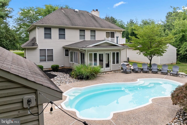 705 Franklinville Rd, Mullica Hill, NJ 08062 - back of house featuring roof with shingles, a chimney, a patio area, and an outdoor pool