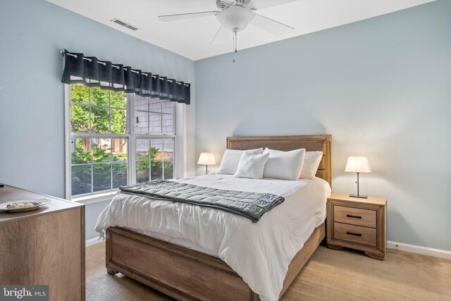 bedroom featuring ceiling fan and light carpet