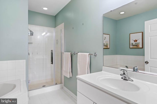 bathroom featuring independent shower and bath, vanity, and tile patterned floors