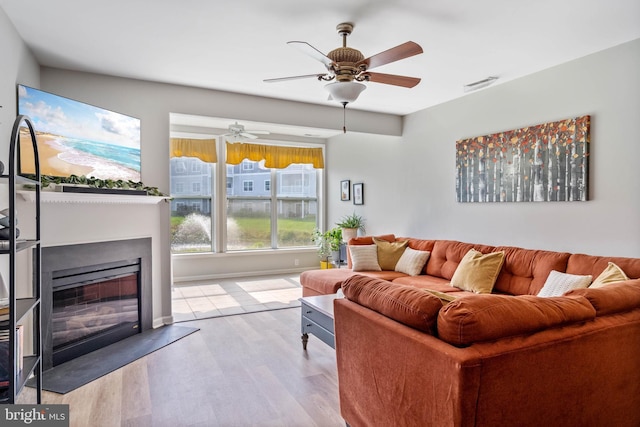 living room with ceiling fan and light wood-type flooring