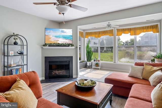 living room featuring hardwood / wood-style floors and ceiling fan