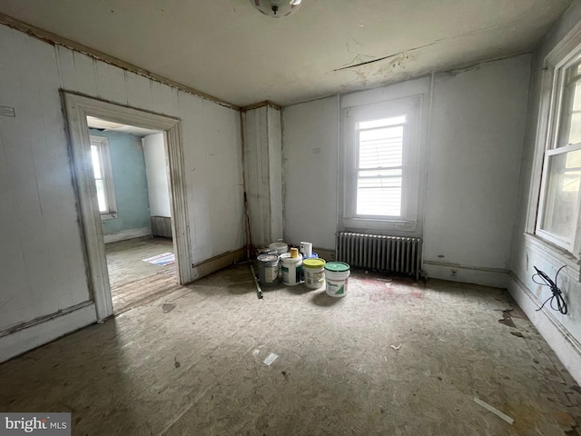 spare room featuring radiator heating unit