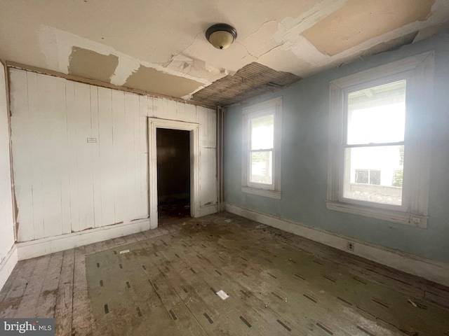 unfurnished room with hardwood / wood-style floors