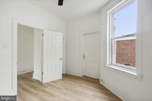 unfurnished bedroom with light wood-type flooring and ceiling fan