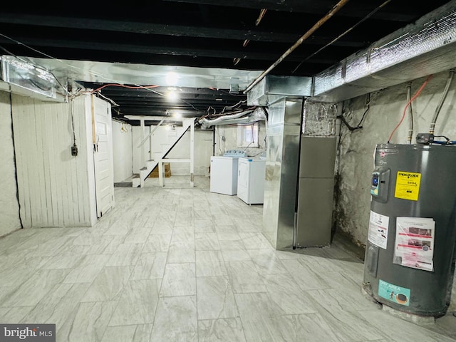 basement featuring washing machine and clothes dryer and water heater