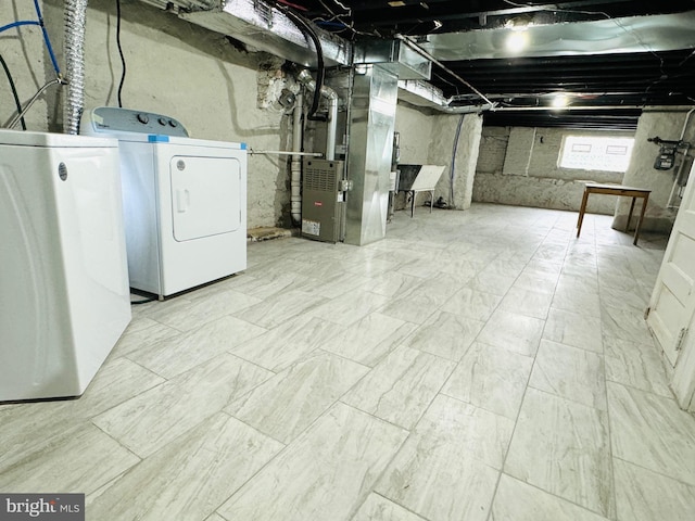 basement featuring heating unit and washer and dryer