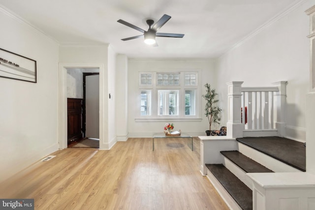 interior space with light hardwood / wood-style floors, ceiling fan, and crown molding