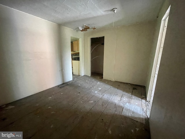 spare room featuring wood-type flooring