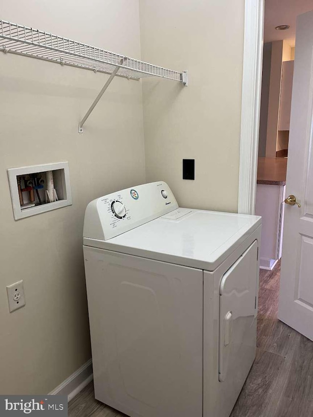 laundry area with washer / dryer and dark wood-type flooring