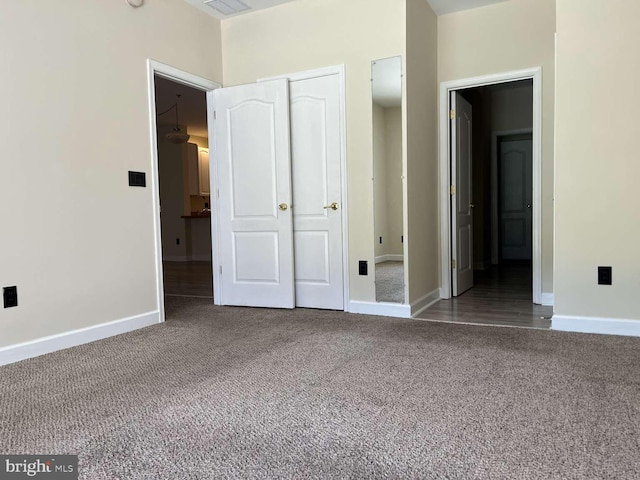 unfurnished bedroom with carpet flooring and a closet