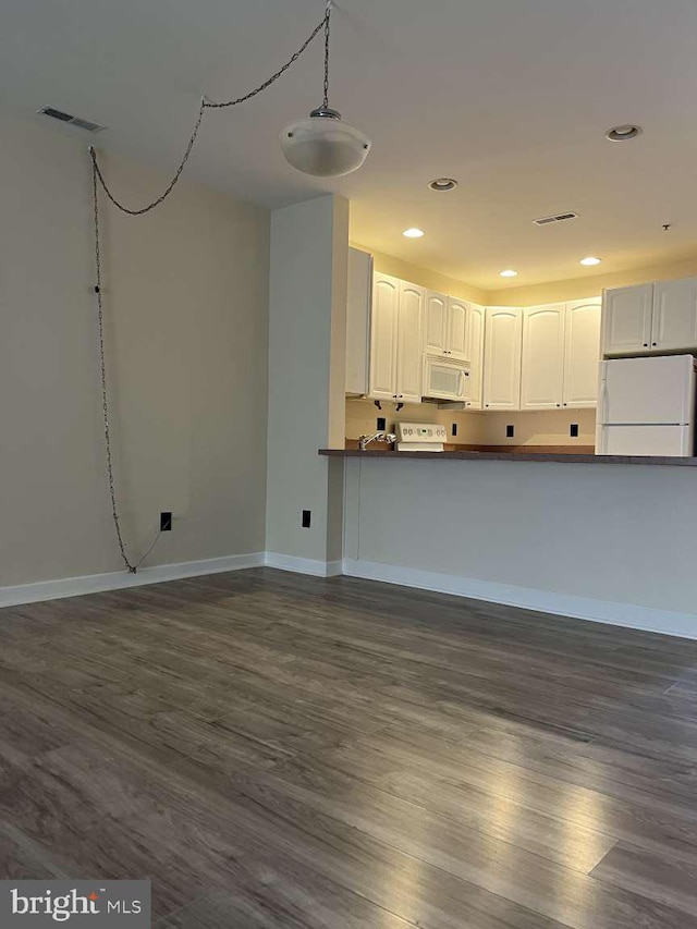 unfurnished living room with dark hardwood / wood-style floors