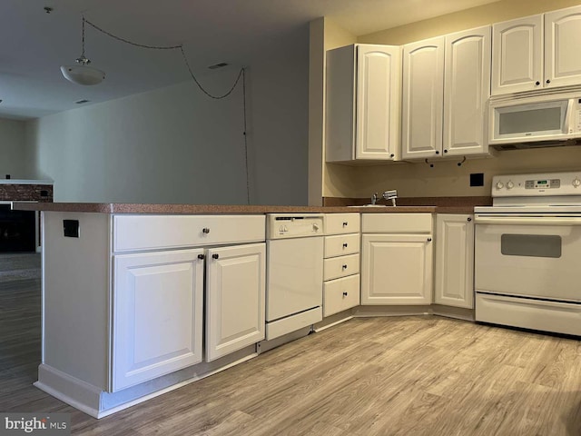 kitchen featuring white cabinets, white appliances, and light hardwood / wood-style flooring