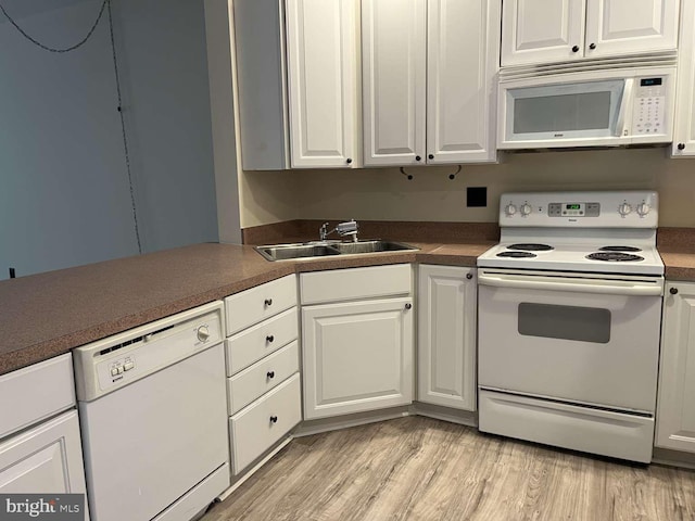 kitchen featuring sink, white cabinets, white appliances, and light hardwood / wood-style flooring