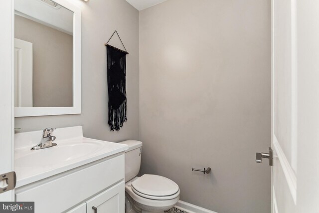 bathroom featuring toilet and vanity