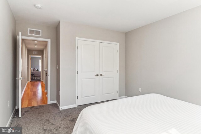 carpeted bedroom with a closet