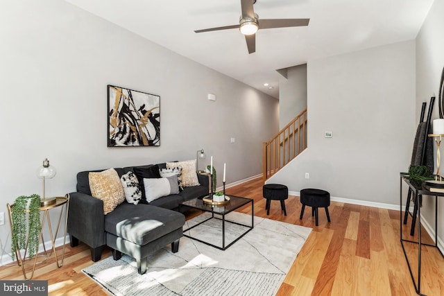 living room featuring ceiling fan and light wood-type flooring