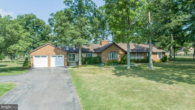 ranch-style house with a garage and a front yard