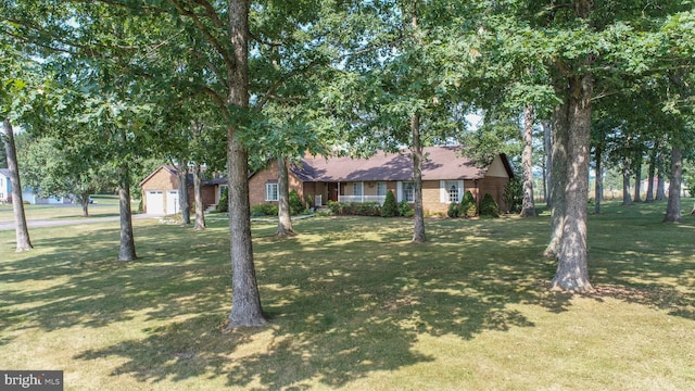 view of front of property with a garage and a front yard