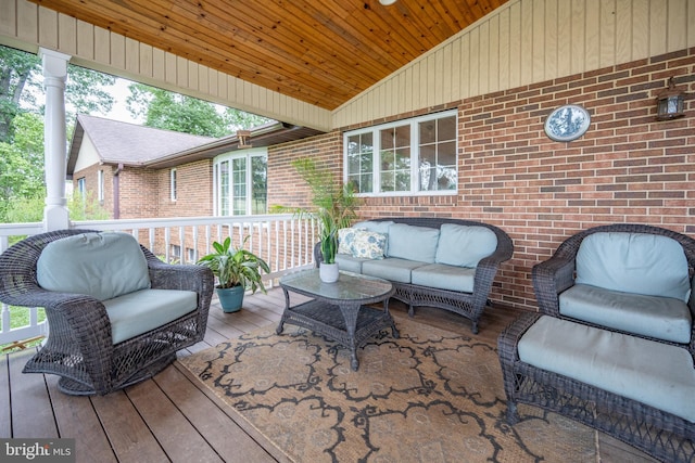 wooden terrace with an outdoor hangout area