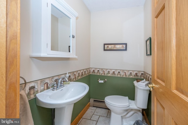 bathroom featuring toilet, baseboard heating, and tile patterned flooring