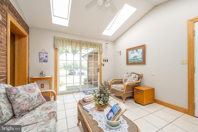 tiled living room featuring lofted ceiling with skylight, brick wall, and ceiling fan