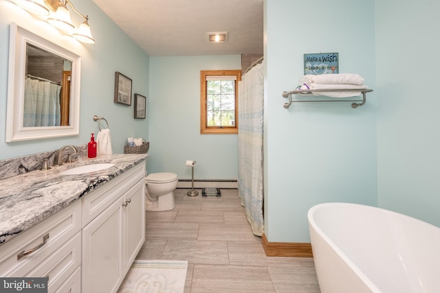 bathroom with tile patterned flooring, a baseboard heating unit, toilet, and vanity