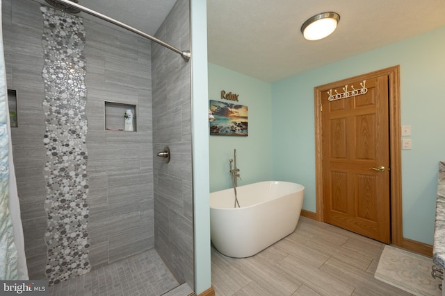 bathroom with tile patterned flooring and shower with separate bathtub