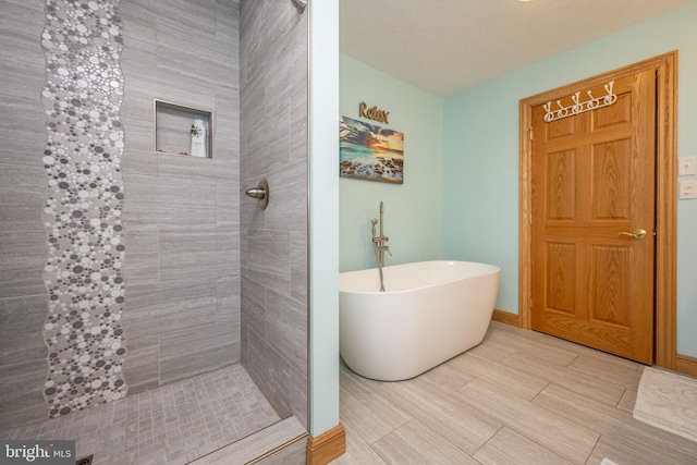 bathroom with shower with separate bathtub and tile patterned floors