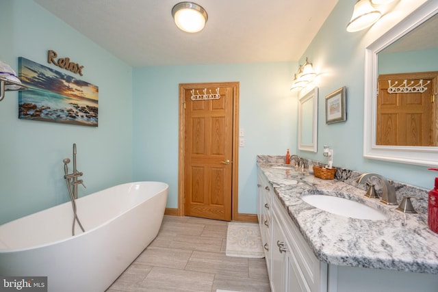 bathroom featuring tile patterned floors, double sink vanity, and a bath