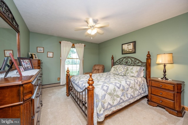 bedroom with a baseboard heating unit, light carpet, a textured ceiling, and ceiling fan