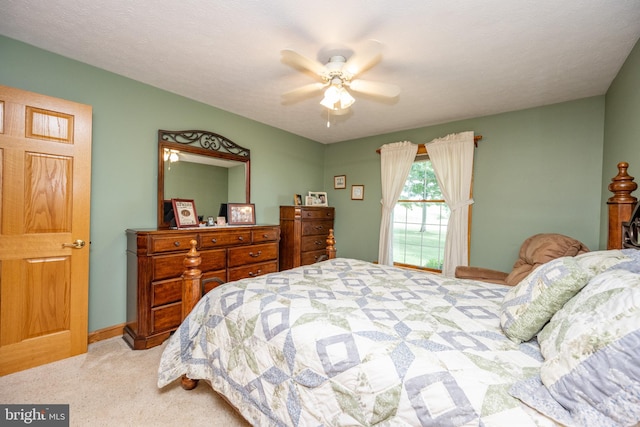 carpeted bedroom with a textured ceiling and ceiling fan