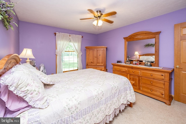 bedroom with light carpet and ceiling fan