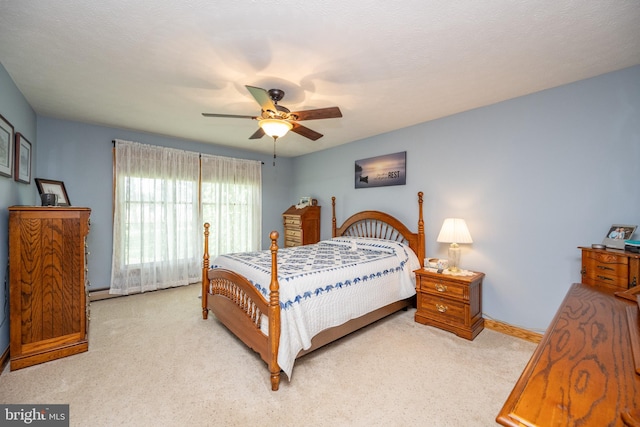 bedroom with ceiling fan and light colored carpet