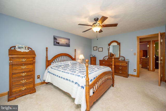 bedroom featuring light colored carpet and ceiling fan