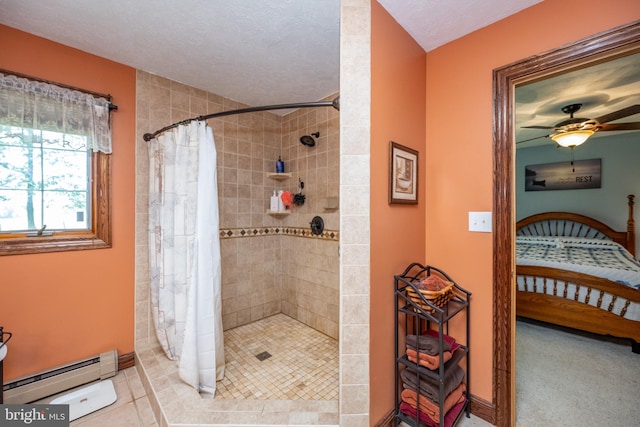 bathroom with ceiling fan, walk in shower, tile patterned flooring, and a baseboard heating unit