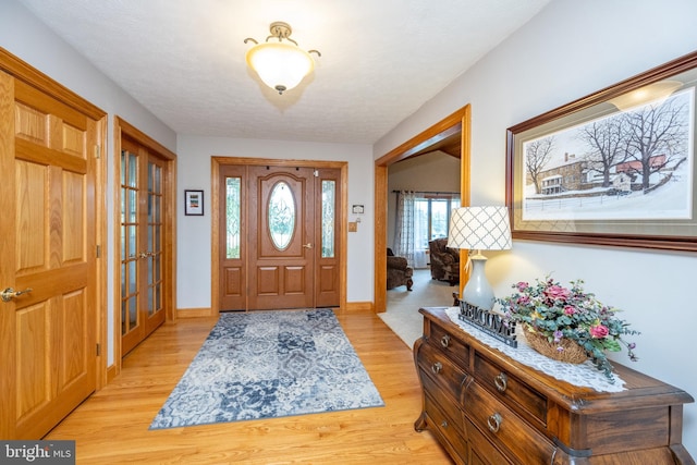 foyer entrance with light wood-type flooring